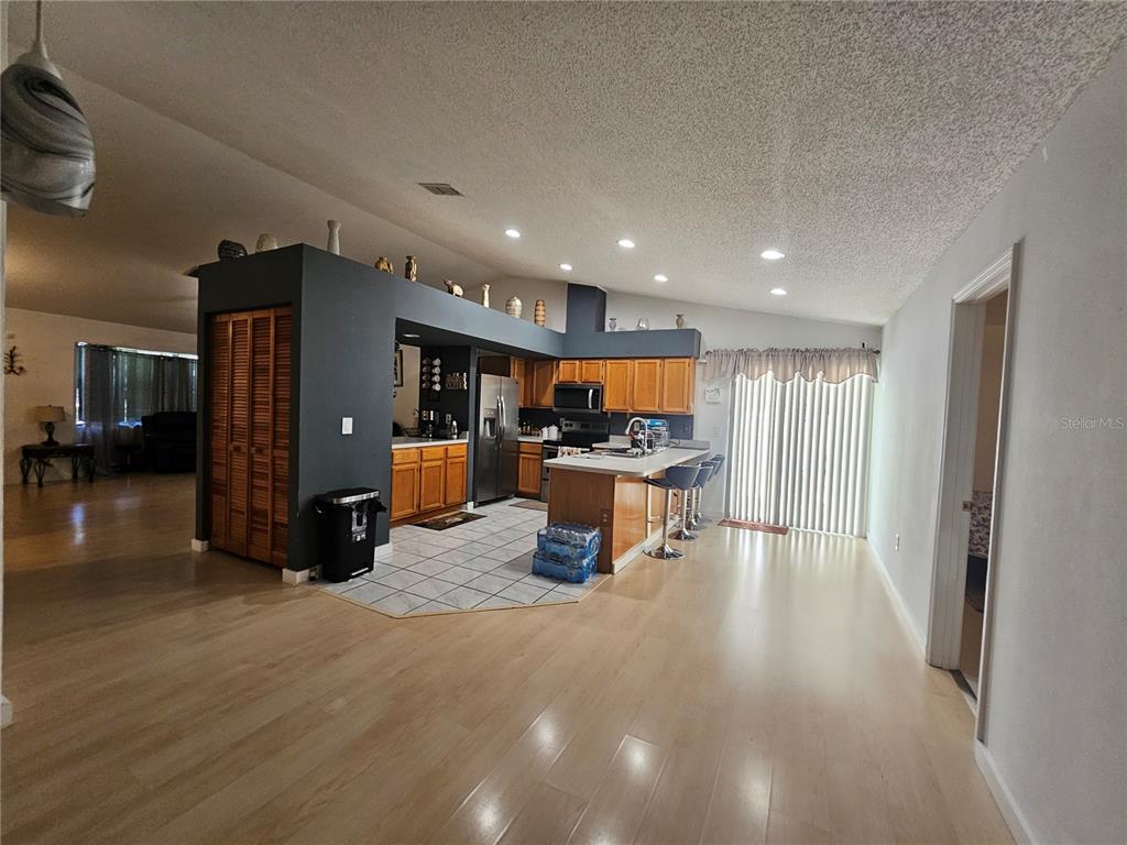 1885 Feather Tree Circle Clearwater, FL 33765 - Photo 11 of 18 a kitchen with stainless steel appliances kitchen island granite countertop a refrigerator and a sink