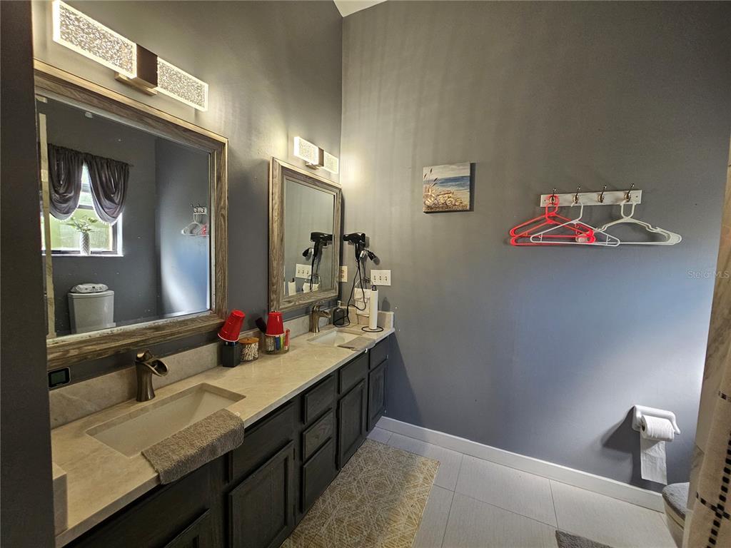1885 Feather Tree Circle Clearwater, FL 33765 - Photo 15 of 18 a bathroom with a sink and a mirror