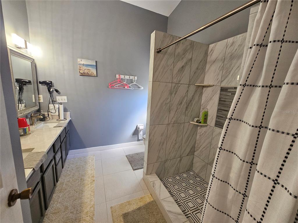 1885 Feather Tree Circle Clearwater, FL 33765 - Photo 16 of 18 a bathroom with a bathtub and shower