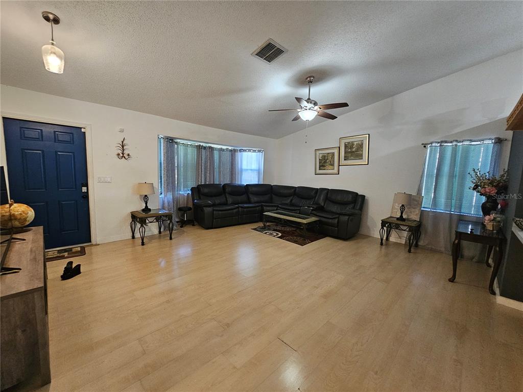 1885 Feather Tree Circle Clearwater, FL 33765 - Photo 4 of 18 a living room with furniture gym equipment and a window