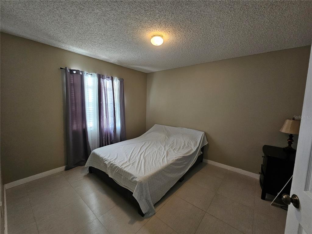 1885 Feather Tree Circle Clearwater, FL 33765 - Photo 6 of 18 a bed sitting in a room next to a window