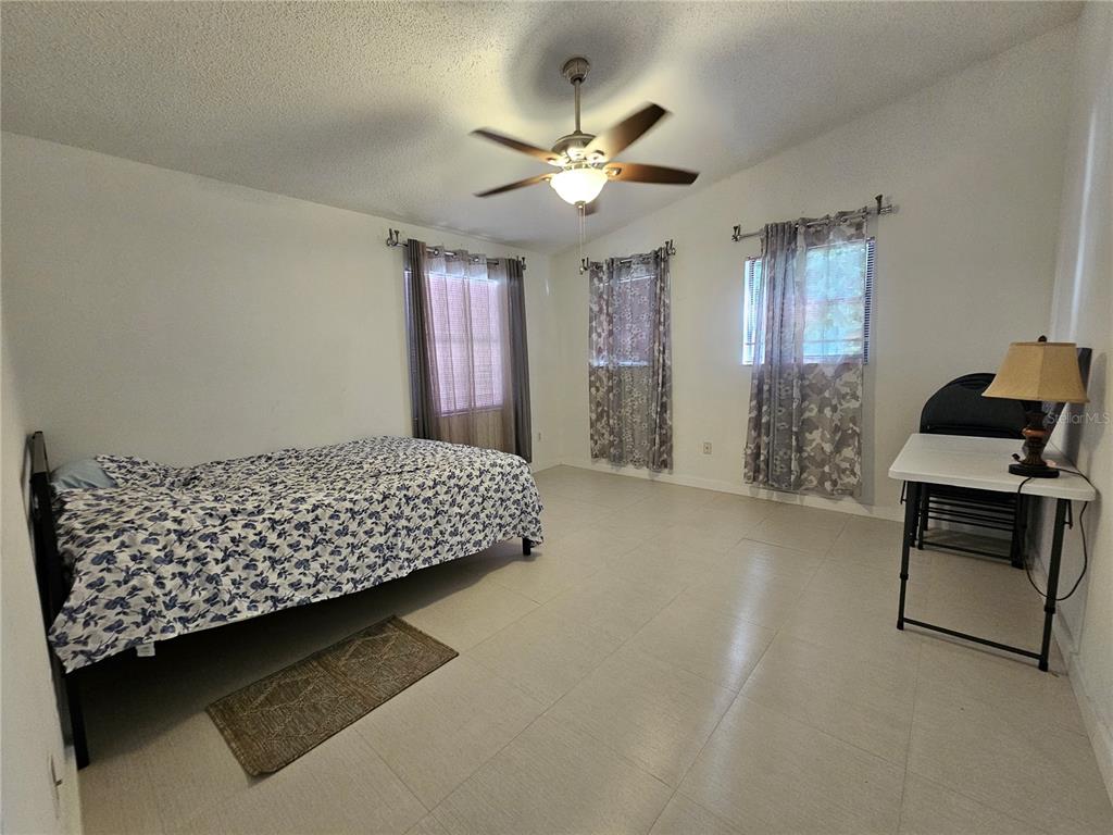 1885 Feather Tree Circle Clearwater, FL 33765 - Photo 8 of 18 a bedroom with a bed and window