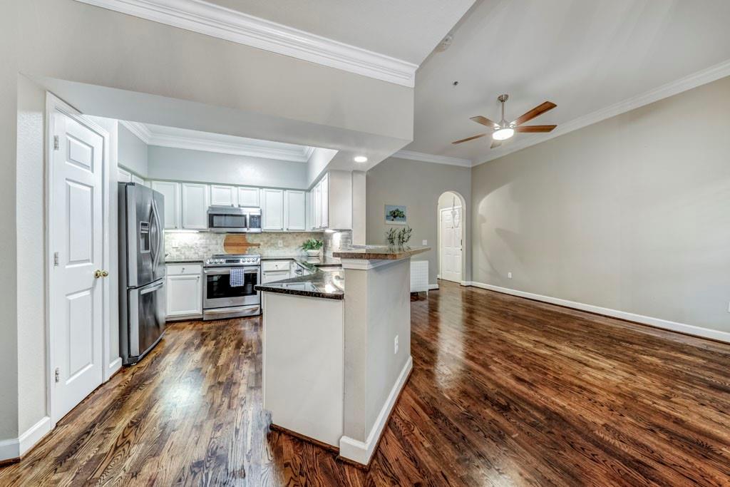 a kitchen with refrigerator and cabinets