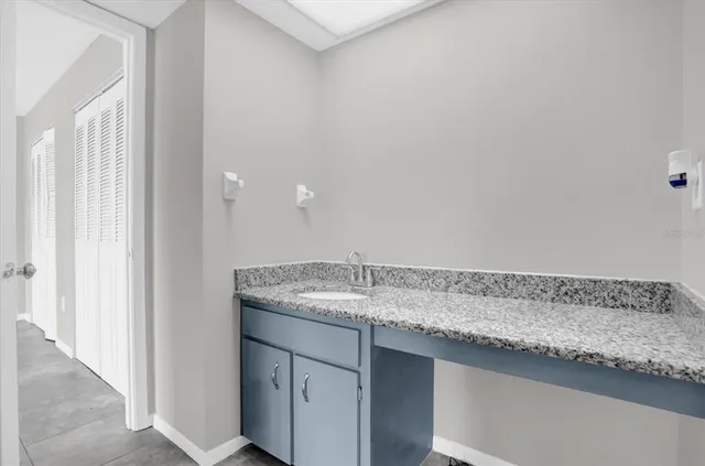 a bathroom with a granite countertop sink and vanity