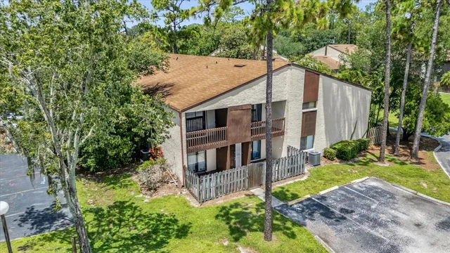 a view of a house with a yard and plants