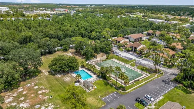 an aerial view of residential houses with outdoor space and swimming pool