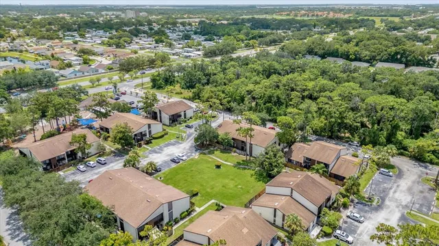 an aerial view of multiple houses with yard