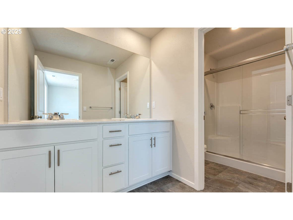 2957 U Street Springfield, OR 97477 - Photo 13 of 22 a bathroom with a sink a mirror and a shower