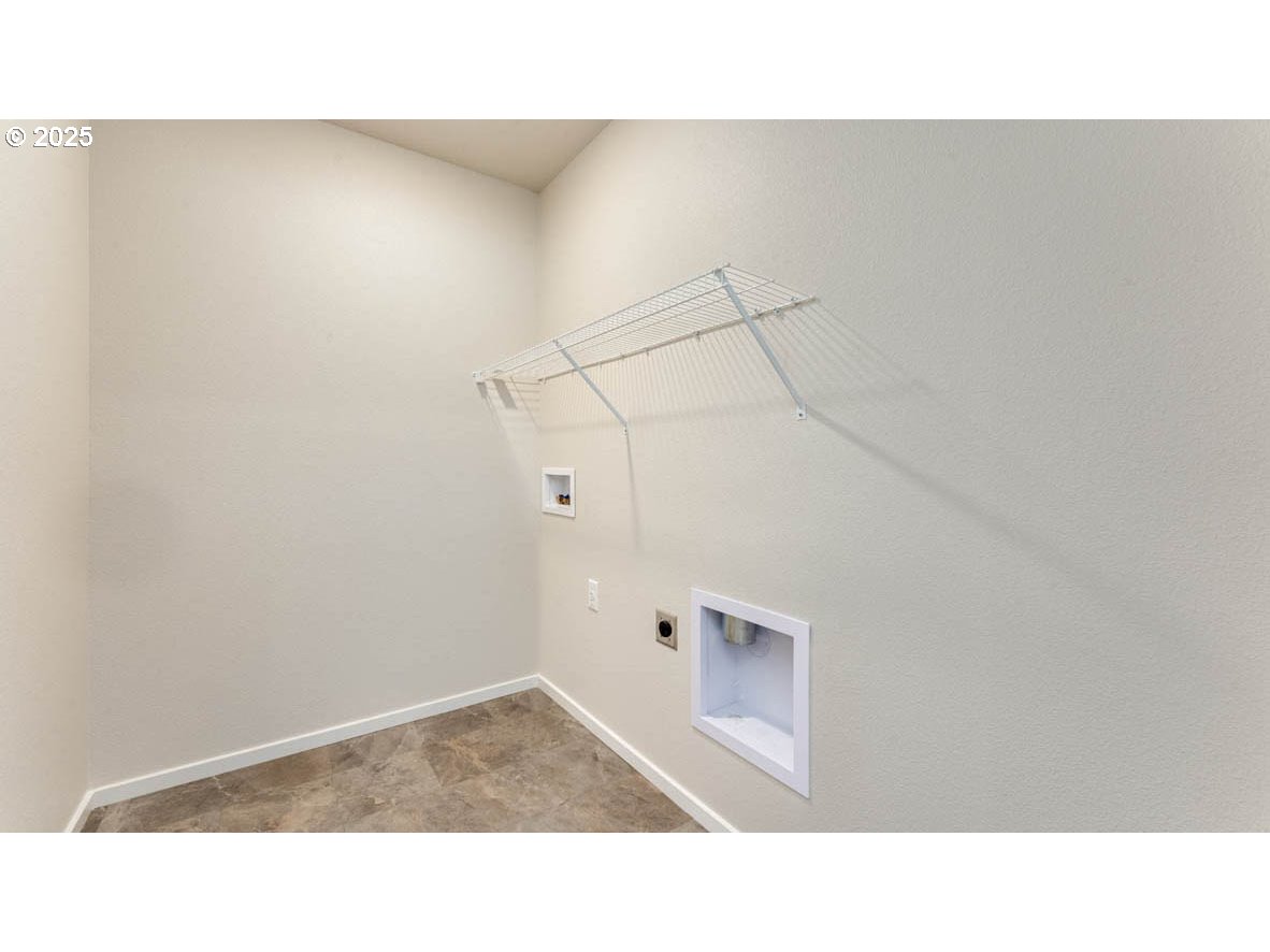 2957 U Street Springfield, OR 97477 - Photo 15 of 22 a open living room with a white wall and a refrigerator