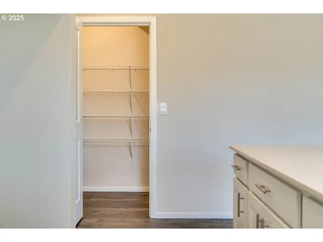 a open space with a cabinet and mirror