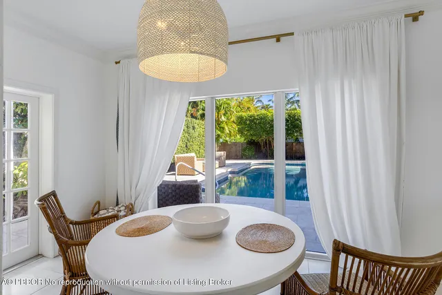 a dining room with furniture and a window