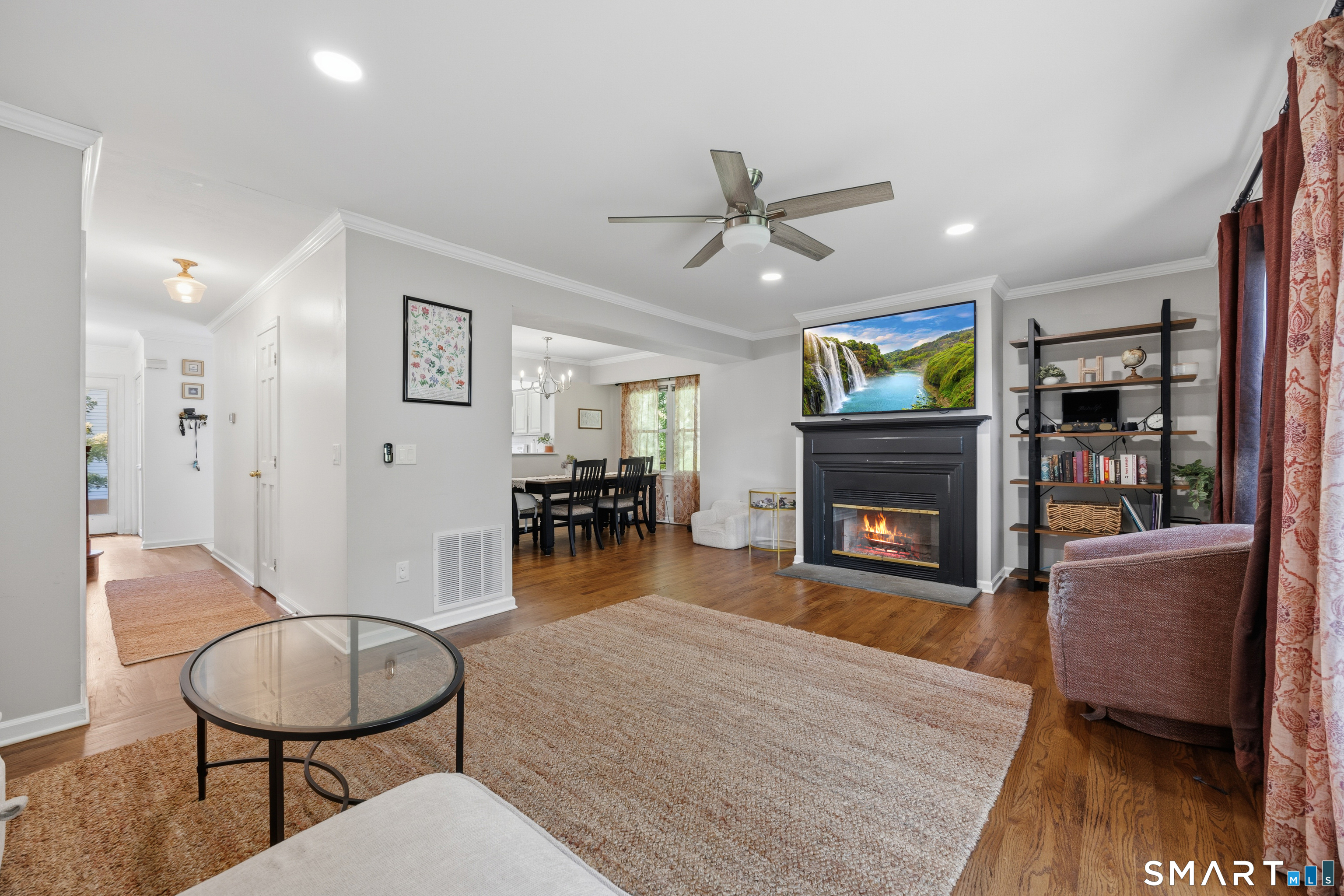 55 Mill Plain Road, Unit 121 Danbury, CT 06811 - Photo 8 of 33 The wood burning fireplace enhances the comfortability and coziness of this space. In addition to removing the popcorn ceilings, new recessed lighting, ceiling fan and crown molding have been added.