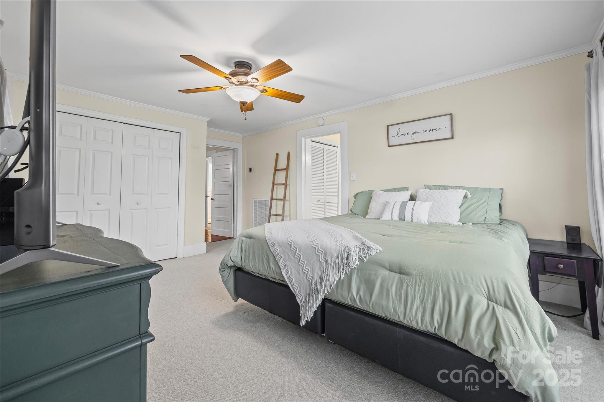 110 Glover Road Gastonia, NC 28056 - Photo 16 of 30 a bedroom with a bed and a chandelier