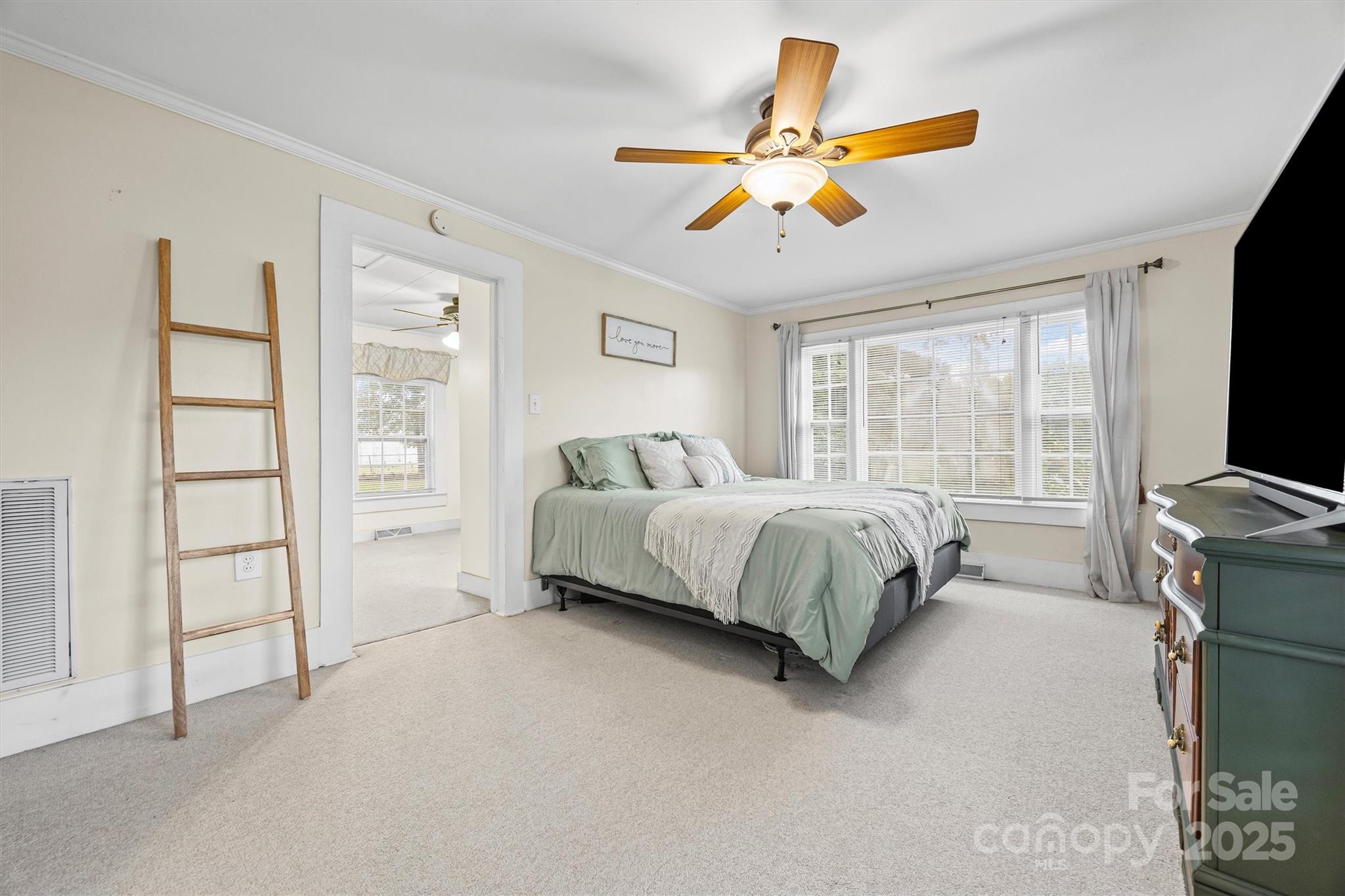 110 Glover Road Gastonia, NC 28056 - Photo 17 of 30 a spacious bedroom with a bed and a flat screen tv