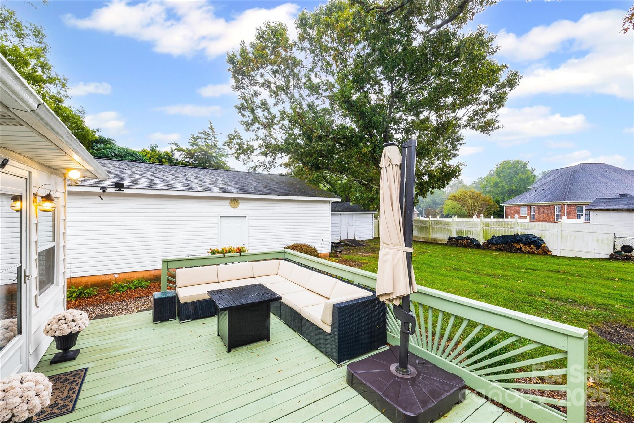 110 Glover Road Gastonia, NC 28056 - Photo 27 of 30 a view of a chair and tables under an umbrella