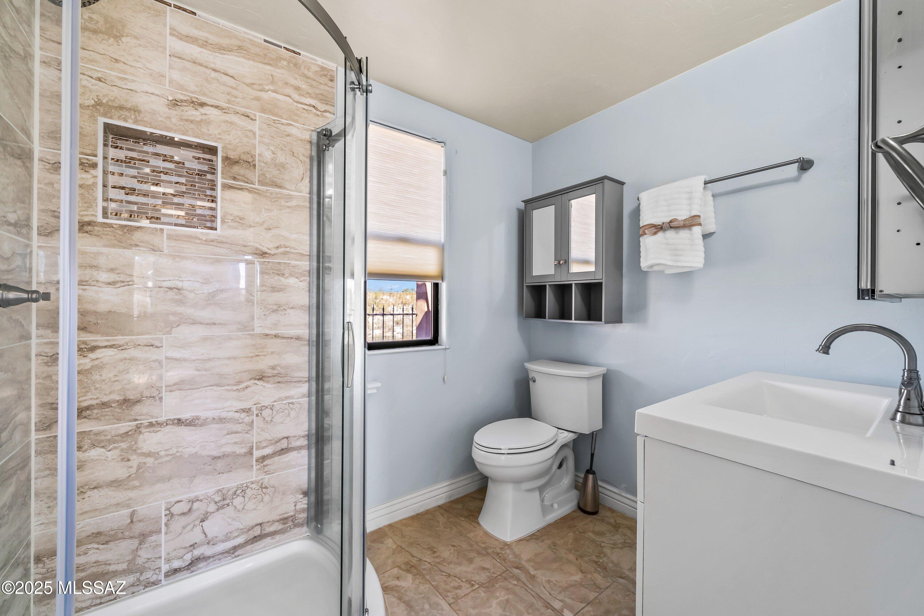 30 West Stone Loop Tucson, AZ 85704 - Photo 22 of 26 a bathroom with a toilet sink and mirror