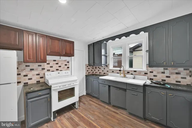 a kitchen with stainless steel appliances a stove sink and cabinets