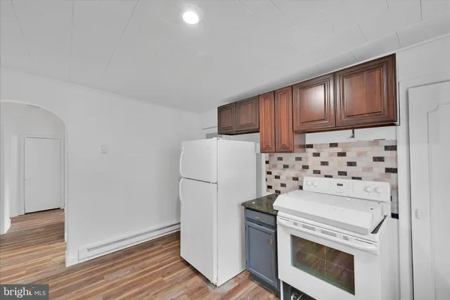 a kitchen with a stove and a refrigerator
