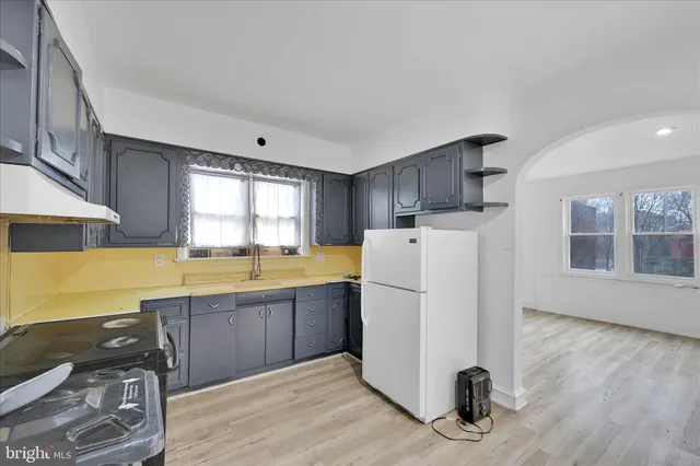a view of a kitchen with a sink dishwasher and a refrigerator