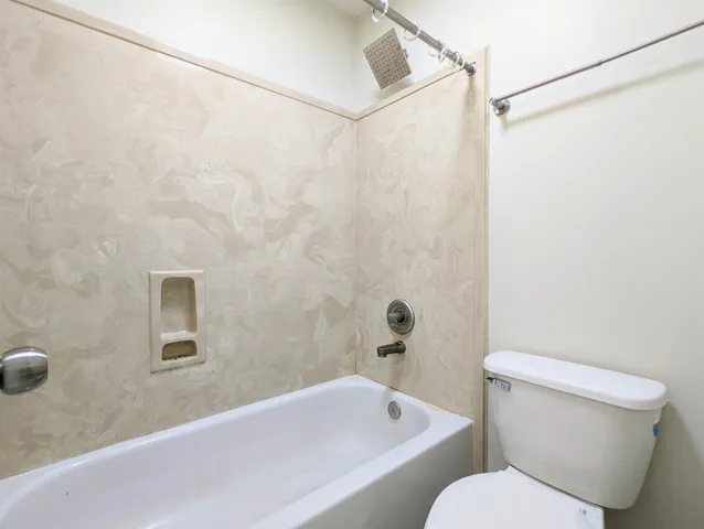 a bathroom with a toilet and a bathtub