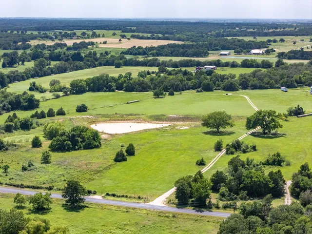 an aerial view of a houses with a lake view