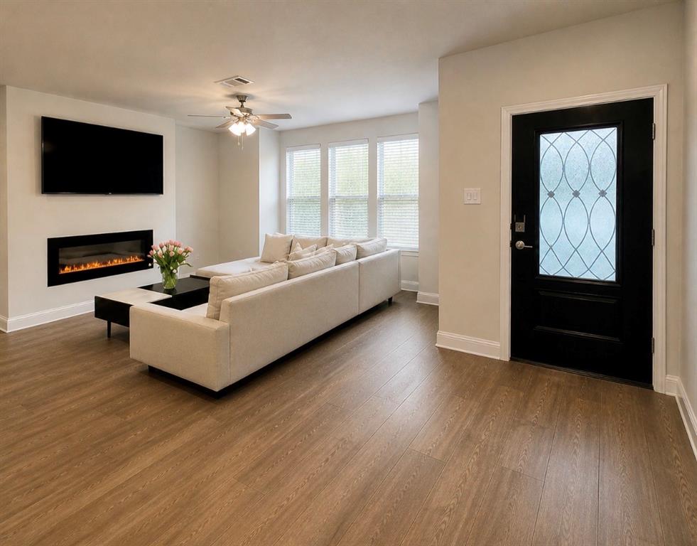 7849 Sunset Boulevard Rowlett, TX 75088 - Photo 2 of 13 a living room with furniture and a flat screen tv