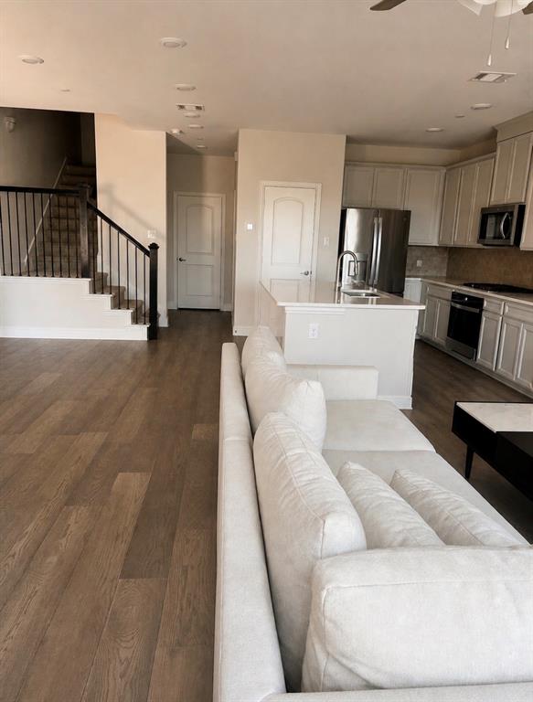 7849 Sunset Boulevard Rowlett, TX 75088 - Photo 3 of 13 a living room with furniture and a flat screen tv