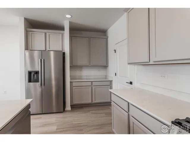 a kitchen with cabinets stainless steel appliances and a sink