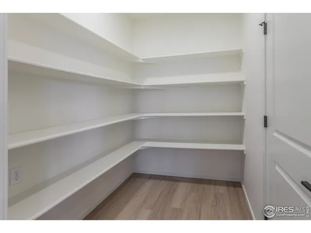 a kitchen with a sink and wooden floor