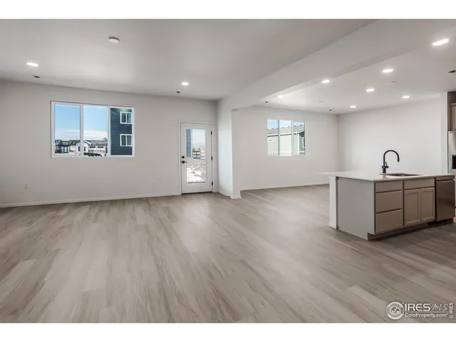 a kitchen with a sink cabinets and wooden floor