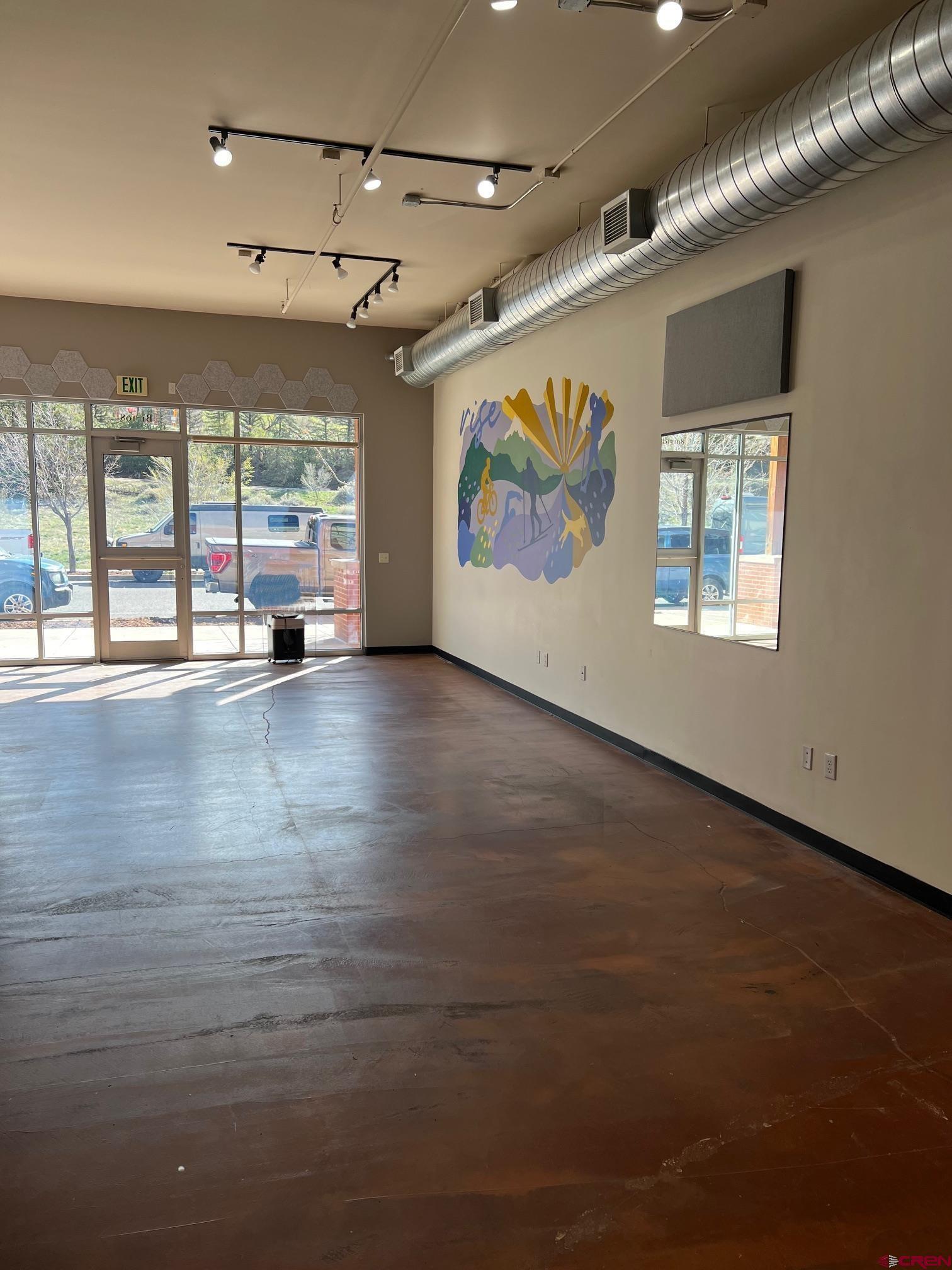 555 Rivergate Lane, Unit 108 Durango, CO 81301 - Photo 8 of 12 an empty room with wooden floor and windows
