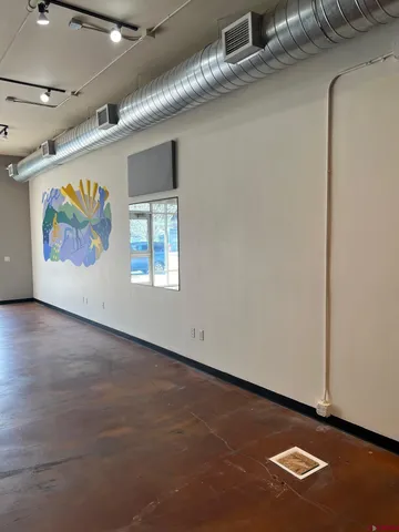 a view of an empty room with gym equipment