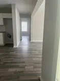 a view of hallway with wooden floor