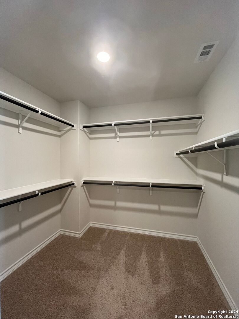 13210 Desana Springs St. Hedwig, TX 78152 - Photo 7 of 16 a view of walk in closet with empty racks