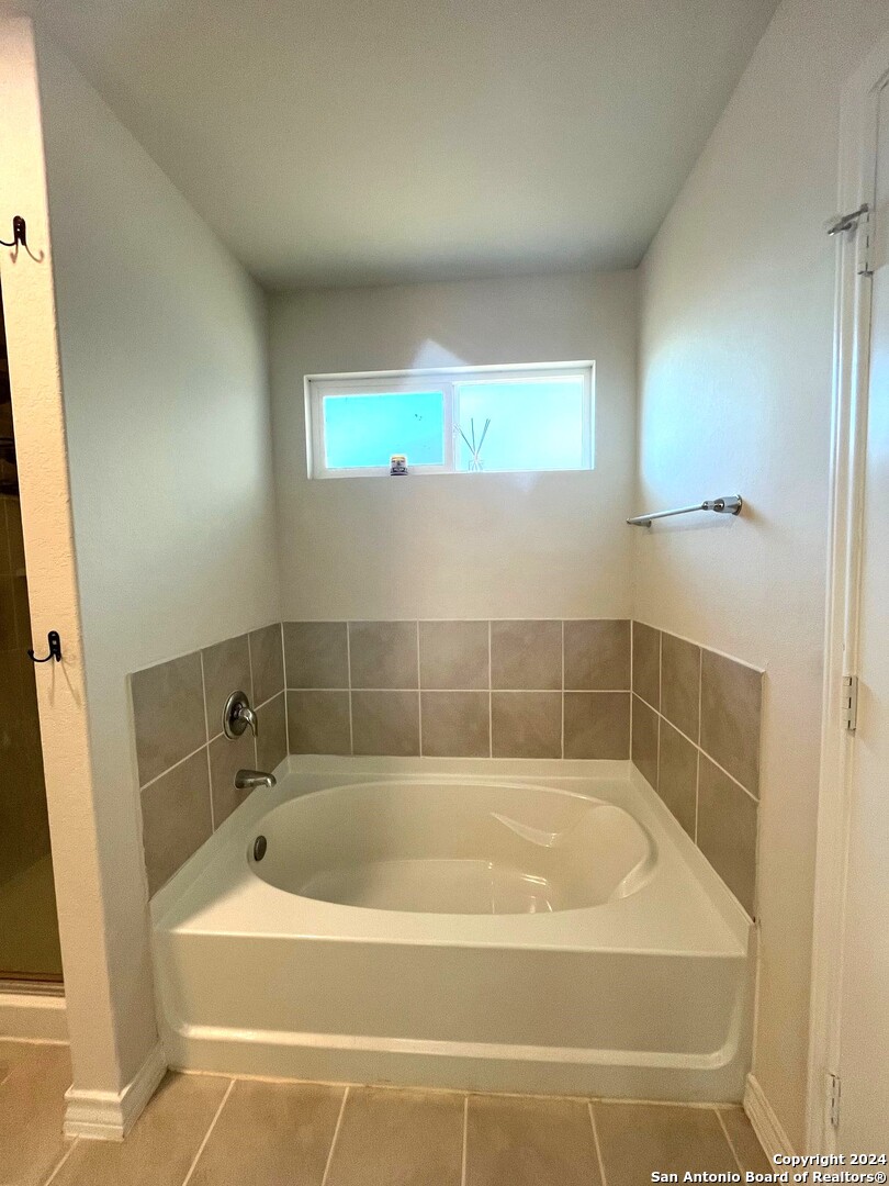 13210 Desana Springs St. Hedwig, TX 78152 - Photo 9 of 16 a bath tub sitting in a bathroom next to a sink