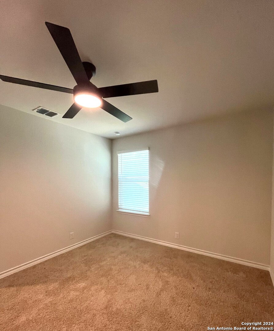 13210 Desana Springs St. Hedwig, TX 78152 - Photo 10 of 16 an empty room with windows and fan