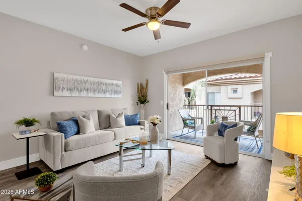 a living room with furniture and kitchen view