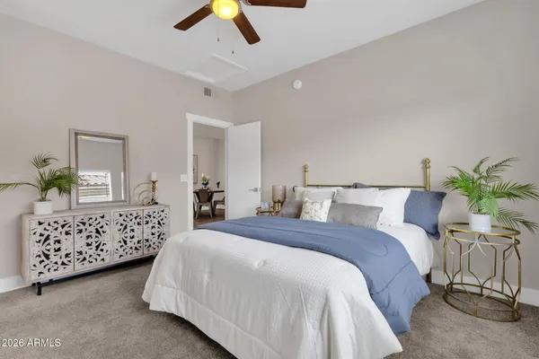 a bedroom with a bed and a chandelier