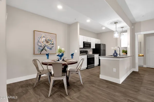 a view of a dining room with furniture kitchen and wooden floor