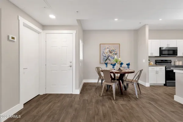 a view of a dining room with furniture and wooden floor