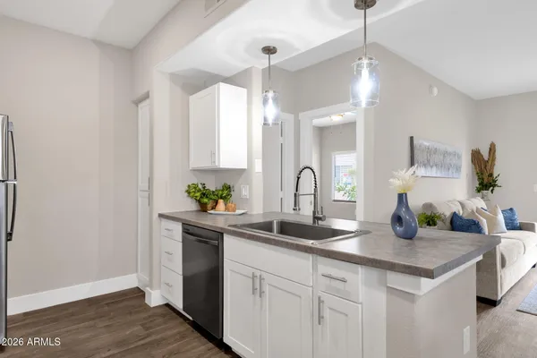a kitchen with sink and refrigerator