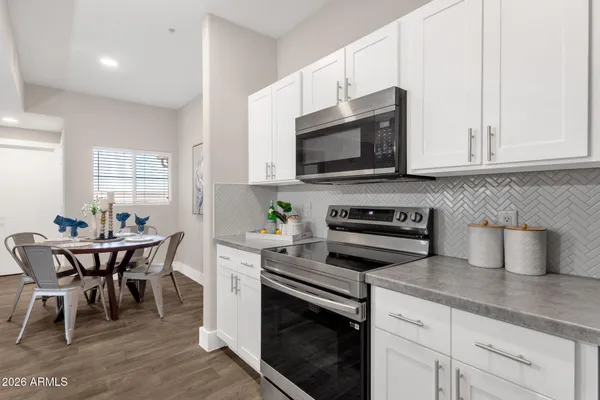a living room with fireplace furniture and a wooden floor