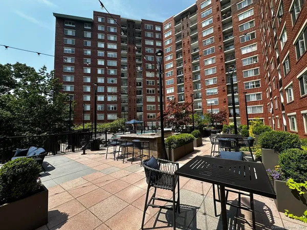 a view of a patio with a table and chairs and potted plants