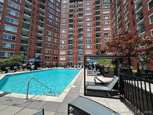 52 Forest Street, Unit 1402 Stamford, CT 06901 - Photo 14 of 23 a view of a patio with a table and chairs