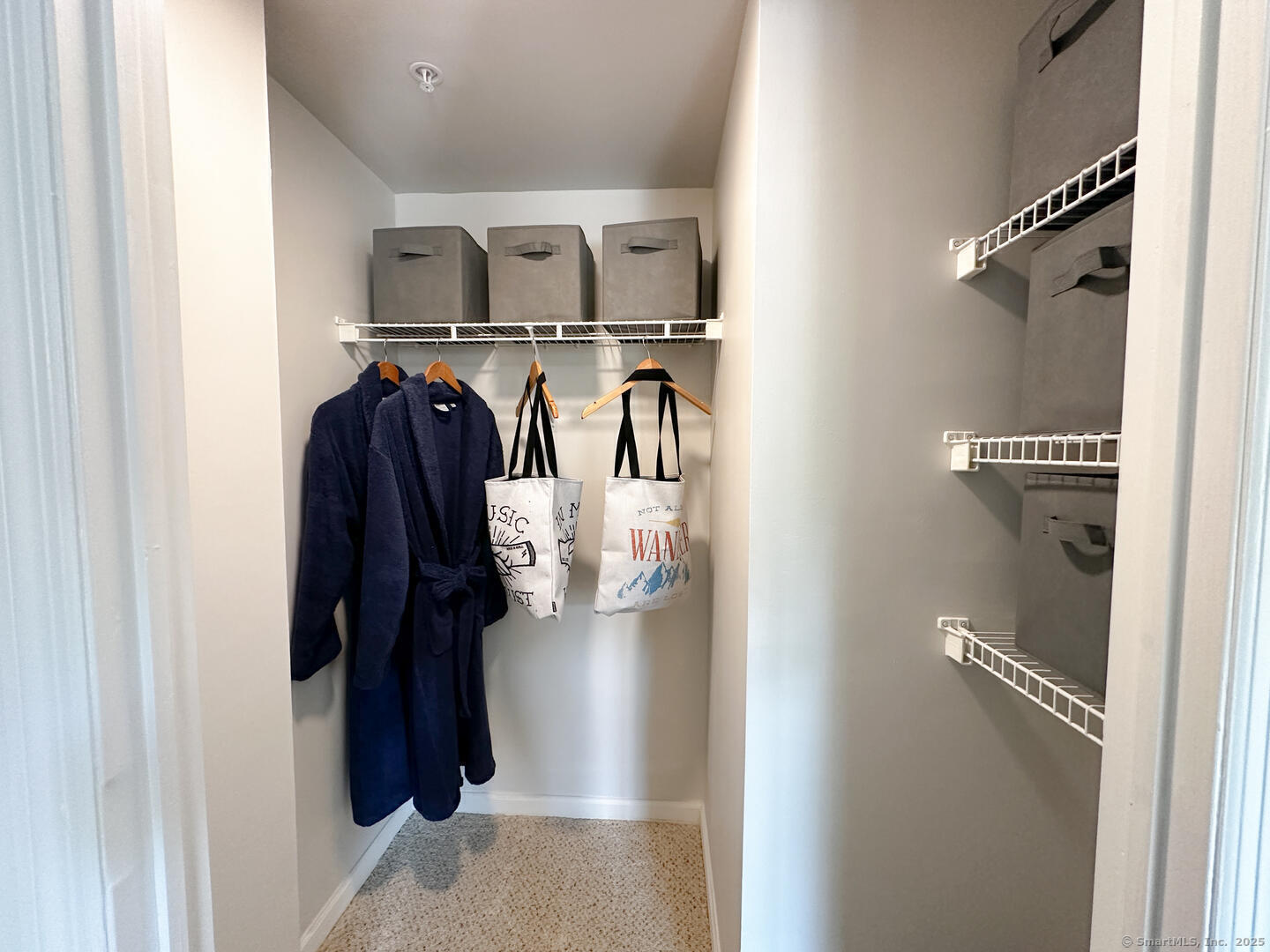 52 Forest Street, Unit 1402 Stamford, CT 06901 - Photo 20 of 23 a view of walk in closet with clothes and shoes