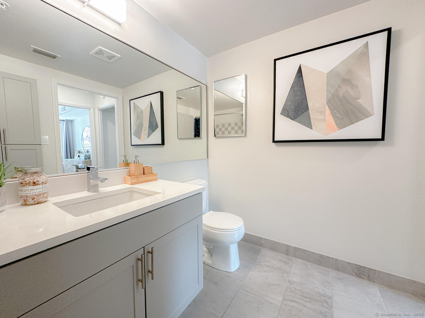 52 Forest Street, Unit 1402 Stamford, CT 06901 - Photo 3 of 23 a bathroom with a toilet sink and mirror