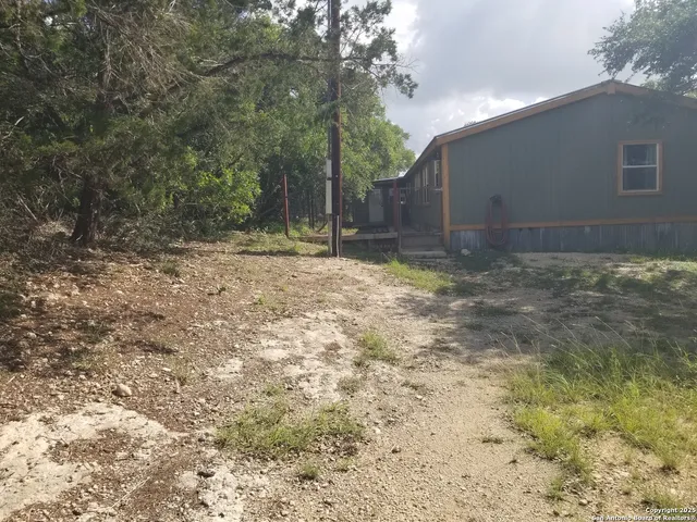 a view of a yard with trees