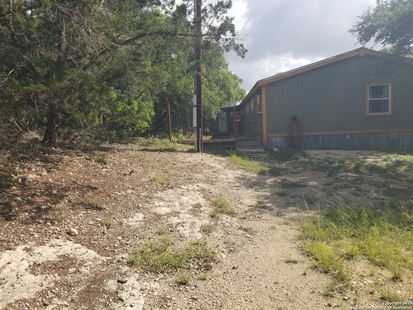 177 Laurel Ridge Drive Lakehills, TX 78063 - Photo 16 of 51 a backyard of a house with lots of green space
