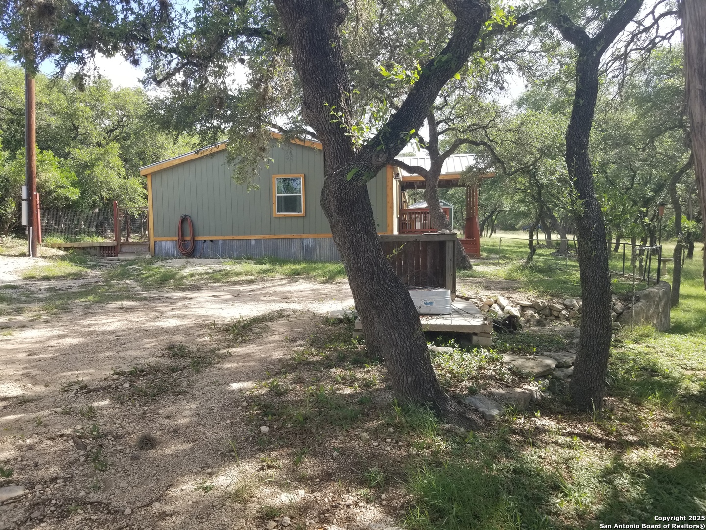 177 Laurel Ridge Drive Lakehills, TX 78063 - Photo 17 of 51 a view of a yard with a tree