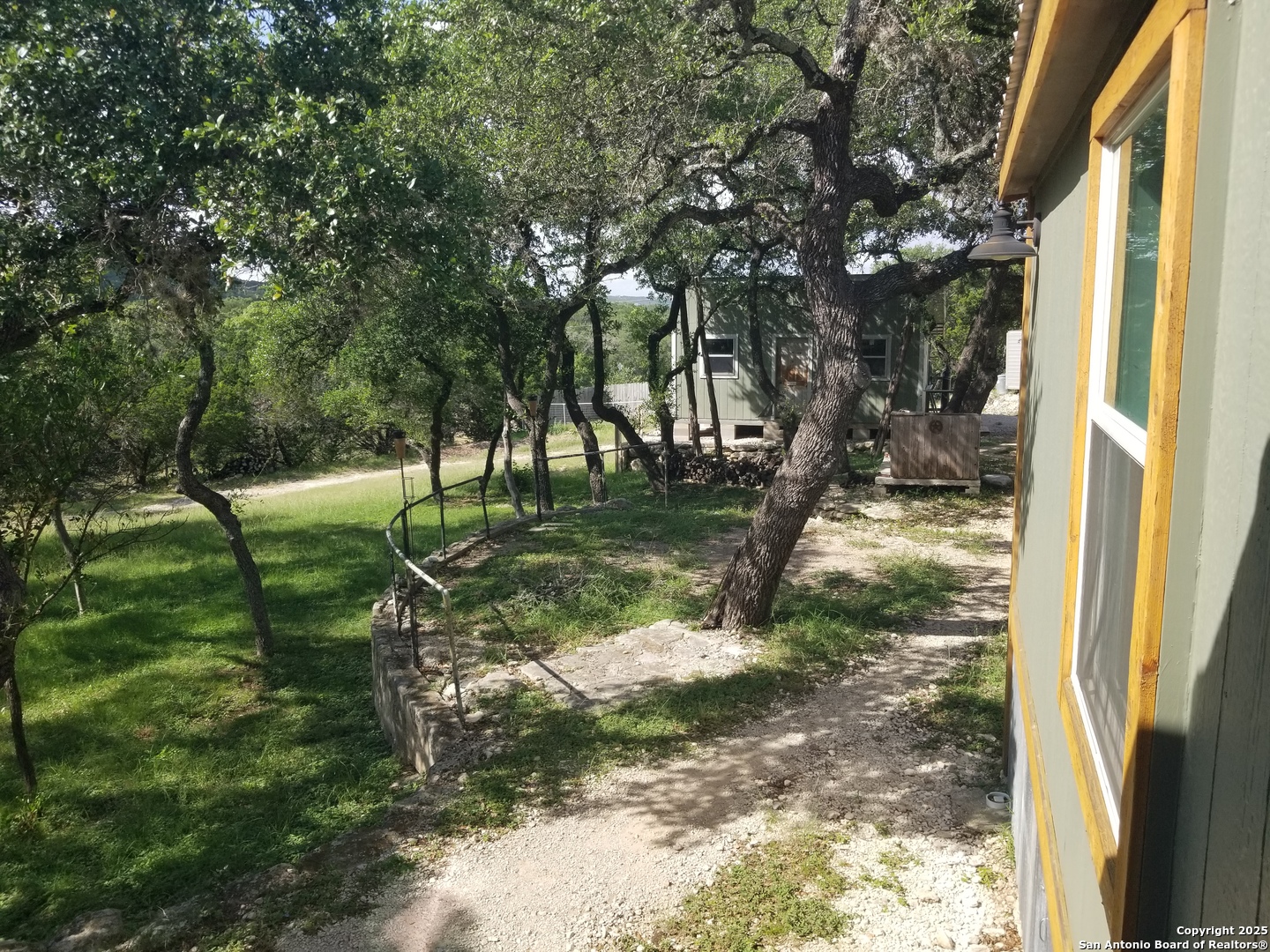 177 Laurel Ridge Drive Lakehills, TX 78063 - Photo 19 of 51 a view of a yard with plants and trees
